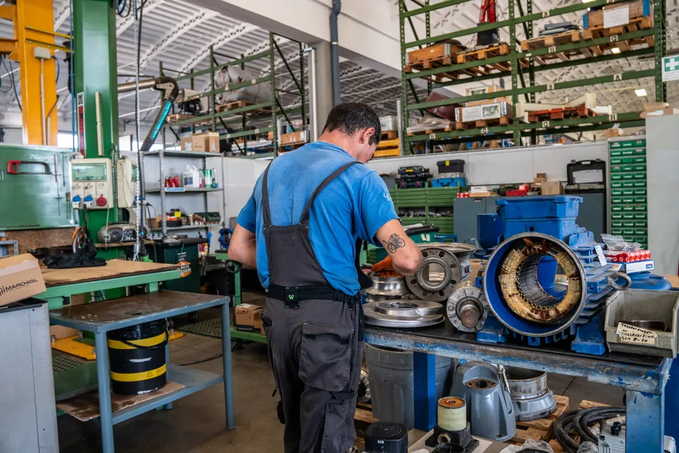 Revisione di un'elettropompa in officina, con lo statore aperto sul banco